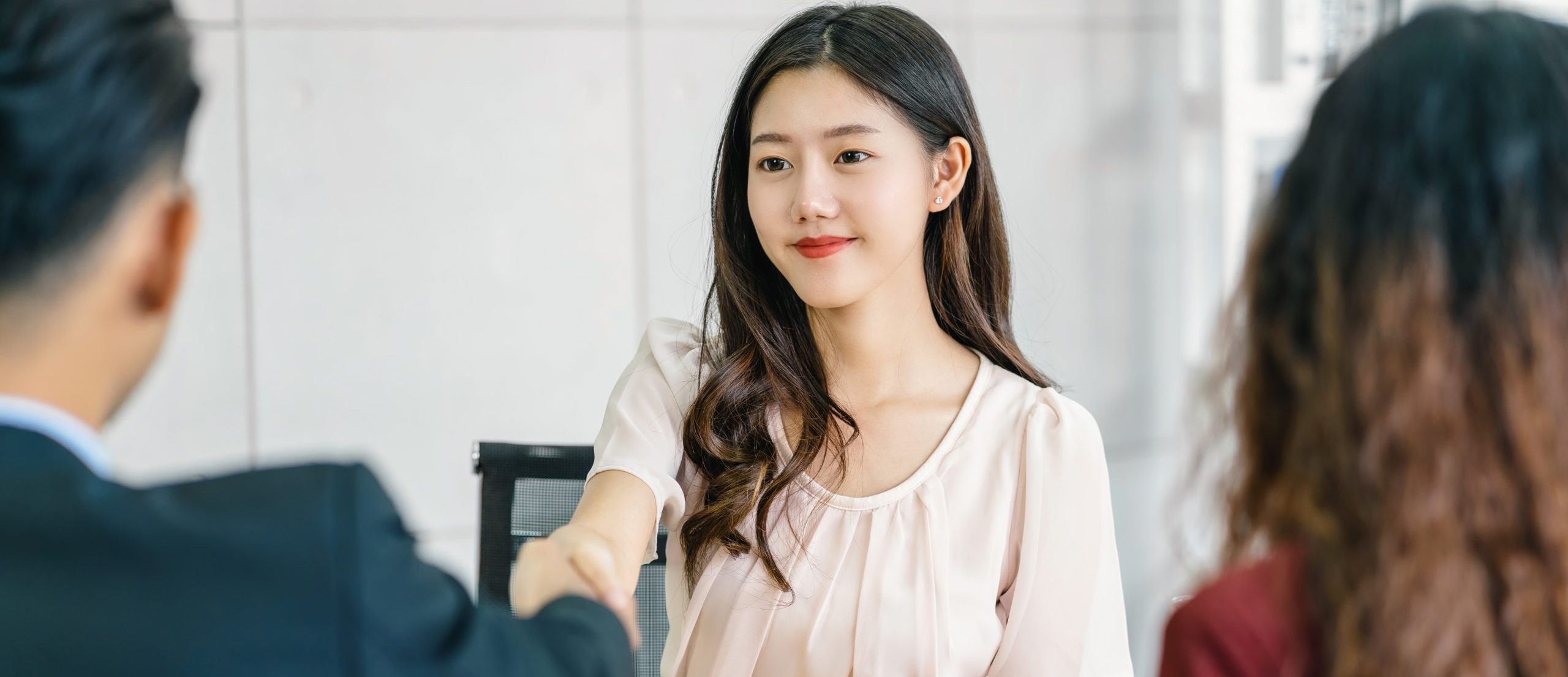 Young Asian woman graduate hand shake with two manager